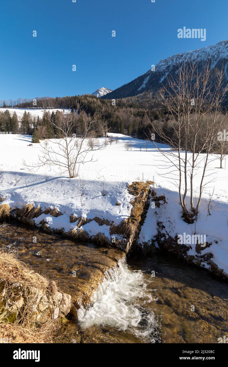 Creek in snowy Ruhpolding, Bavaria, Germany Stock Photo
