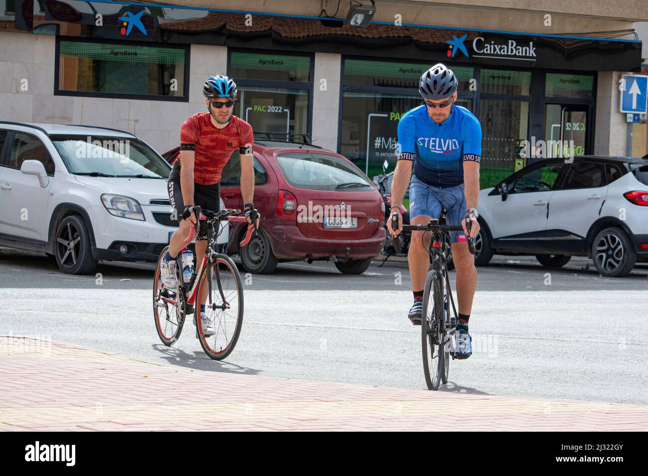 Group of Cyclists arriving the Main square in the Spanish village of Sucina, Murcia Stock Photo