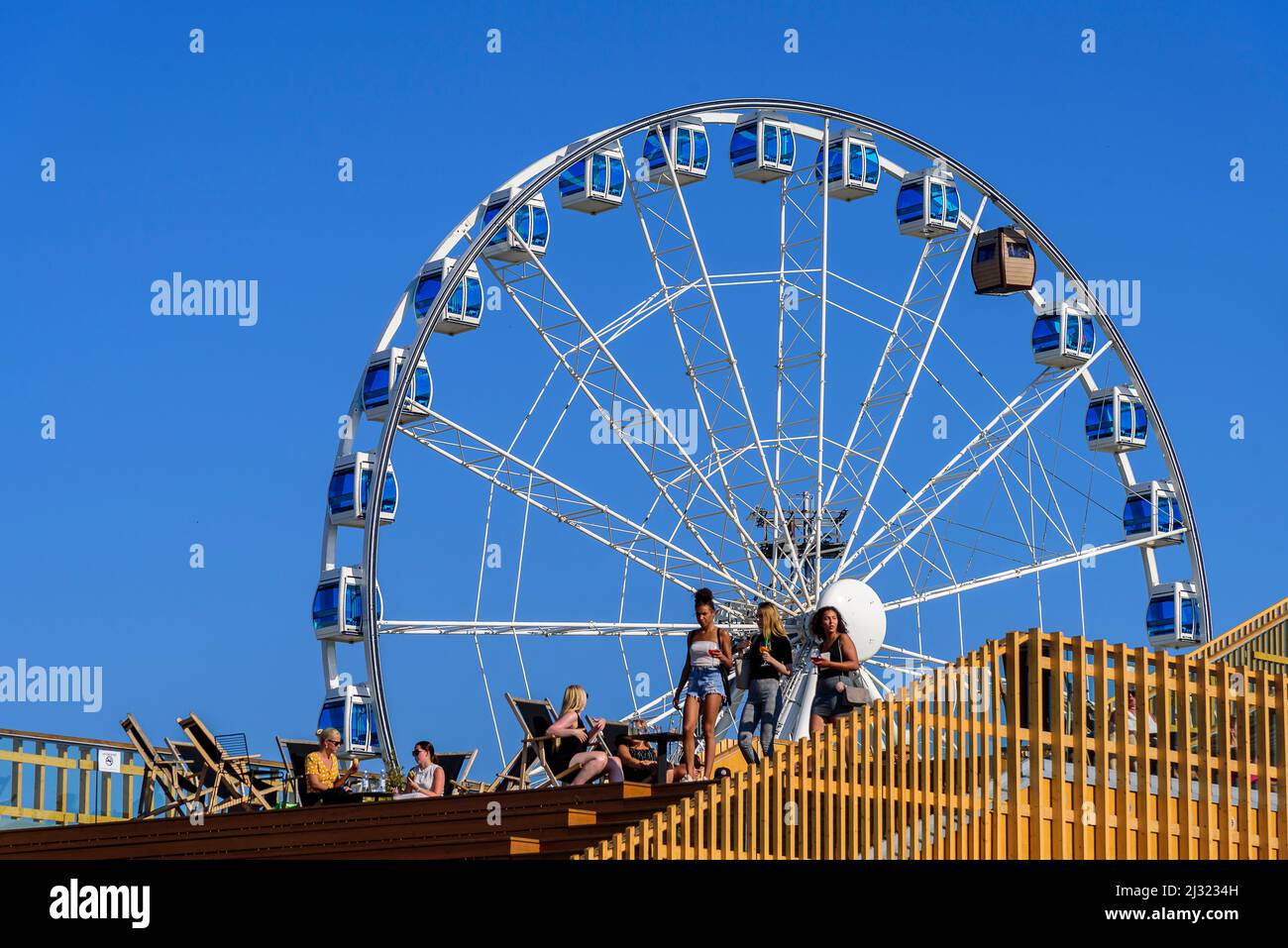 Roof terrace of Allas Sea Pool and ferris wheel with sauna gondola at