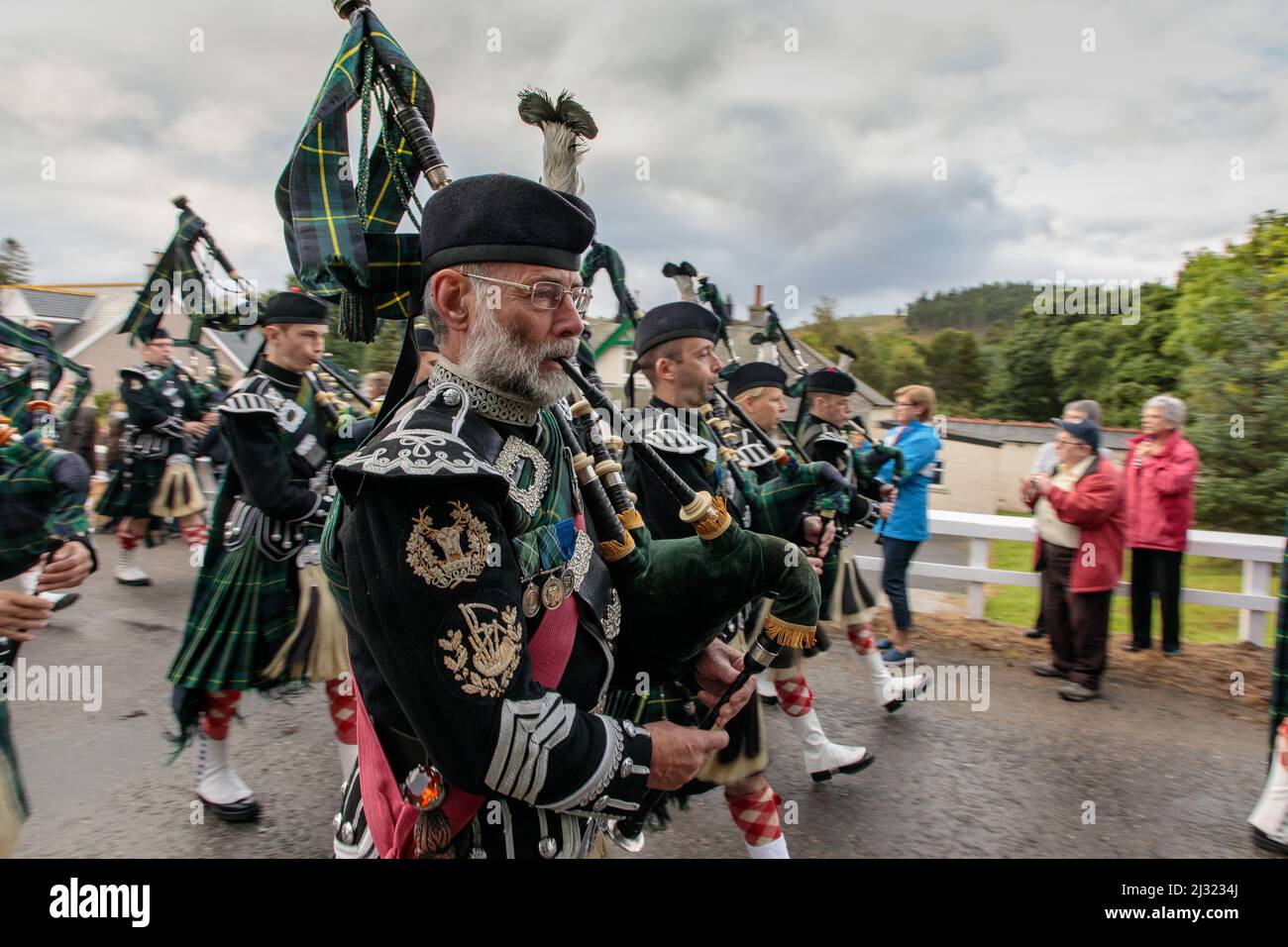 Men of Lonach parade, pipe band in highland dress, bagpipes, Strathdon, Aberdeenshire, Scotland UK Stock Photo