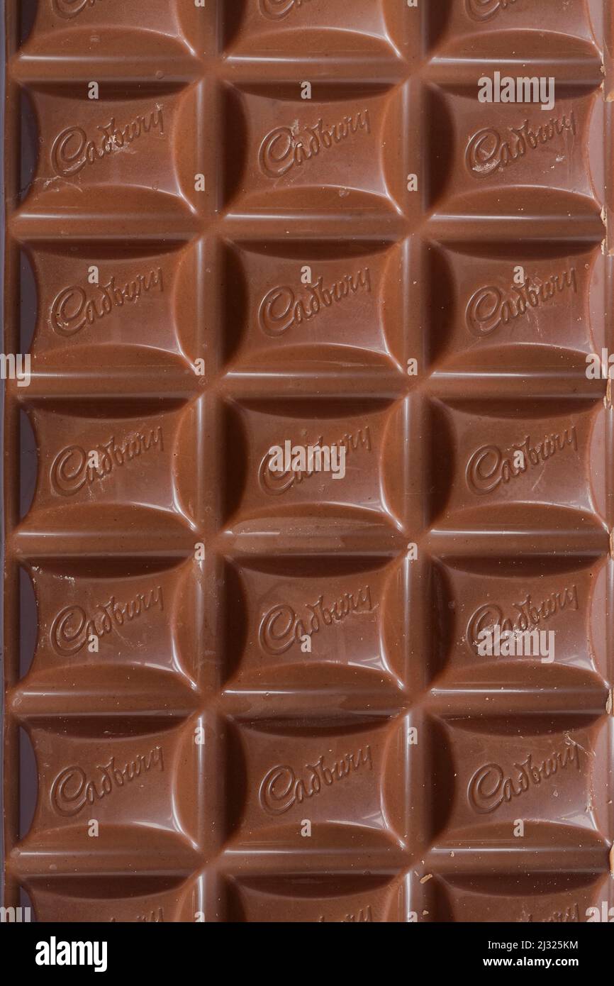 Bar of Cadbury's Dairy Milk milk chocolate bar unwrapped Stock Photo