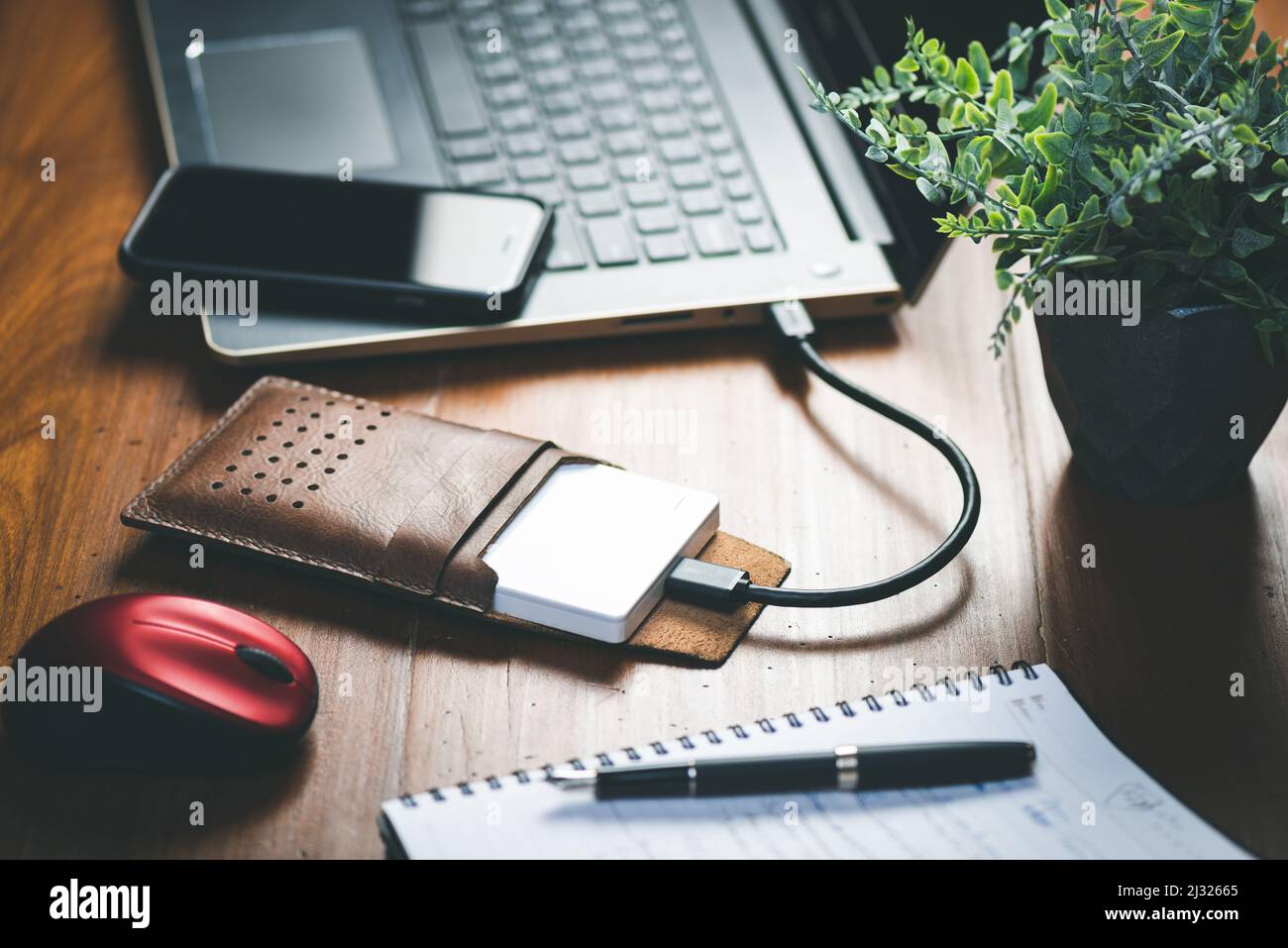 Closeup external hard drive on wooden desktop. Working with external