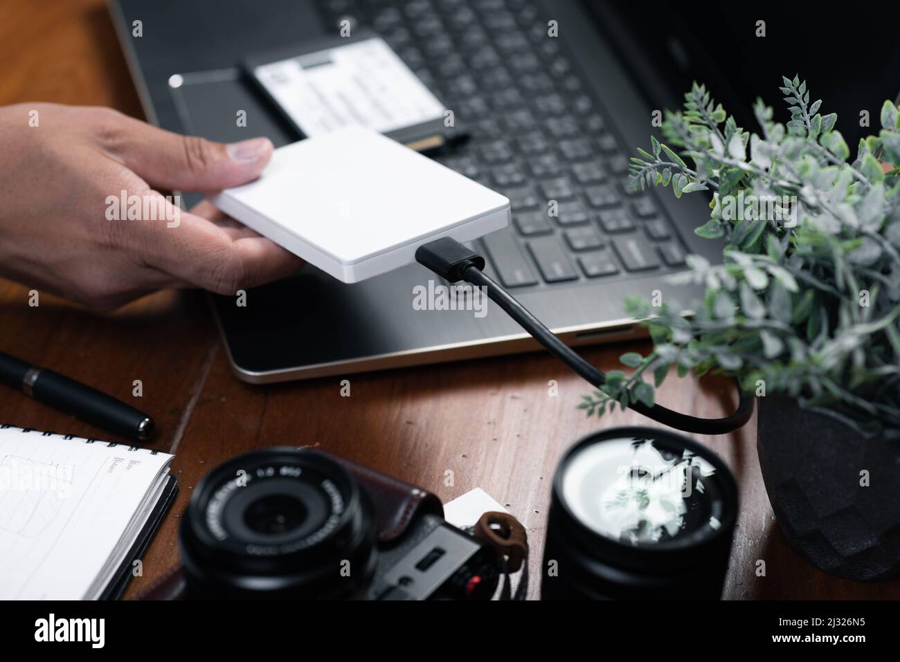 Closeup external hard drive on wooden desktop. Working with external