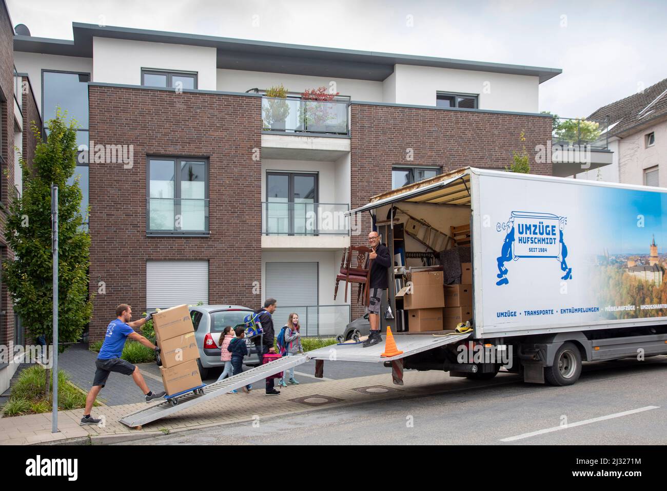 Germany, a  german moving company at work in th city Kleve. The men are moving the belongings from their client into his new house. Stock Photo