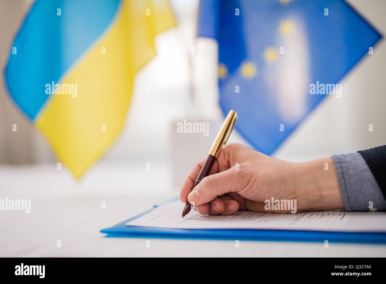 Signing document between European Union and Ukraine, Ukraine joining Europe concept. Stock Photo