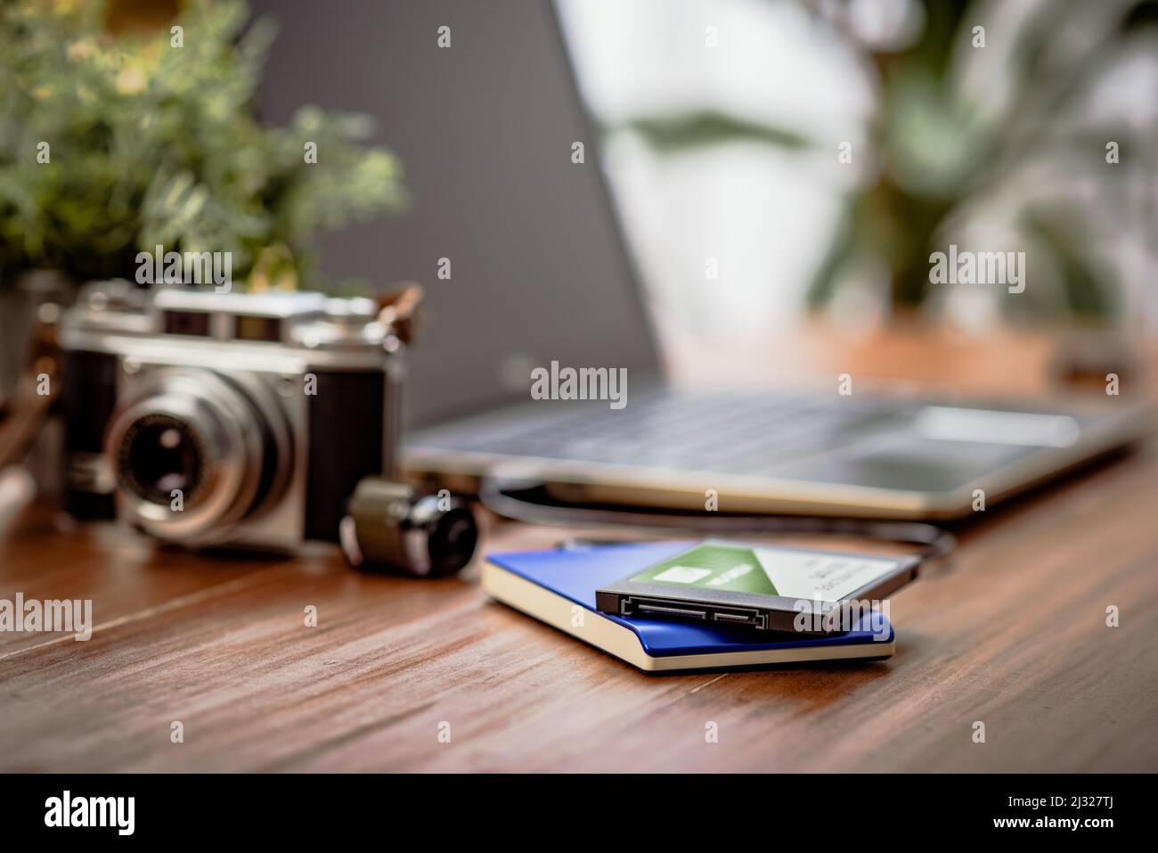 Closeup external hard drive on wooden desktop. Working with external hard drive. Stock Photo