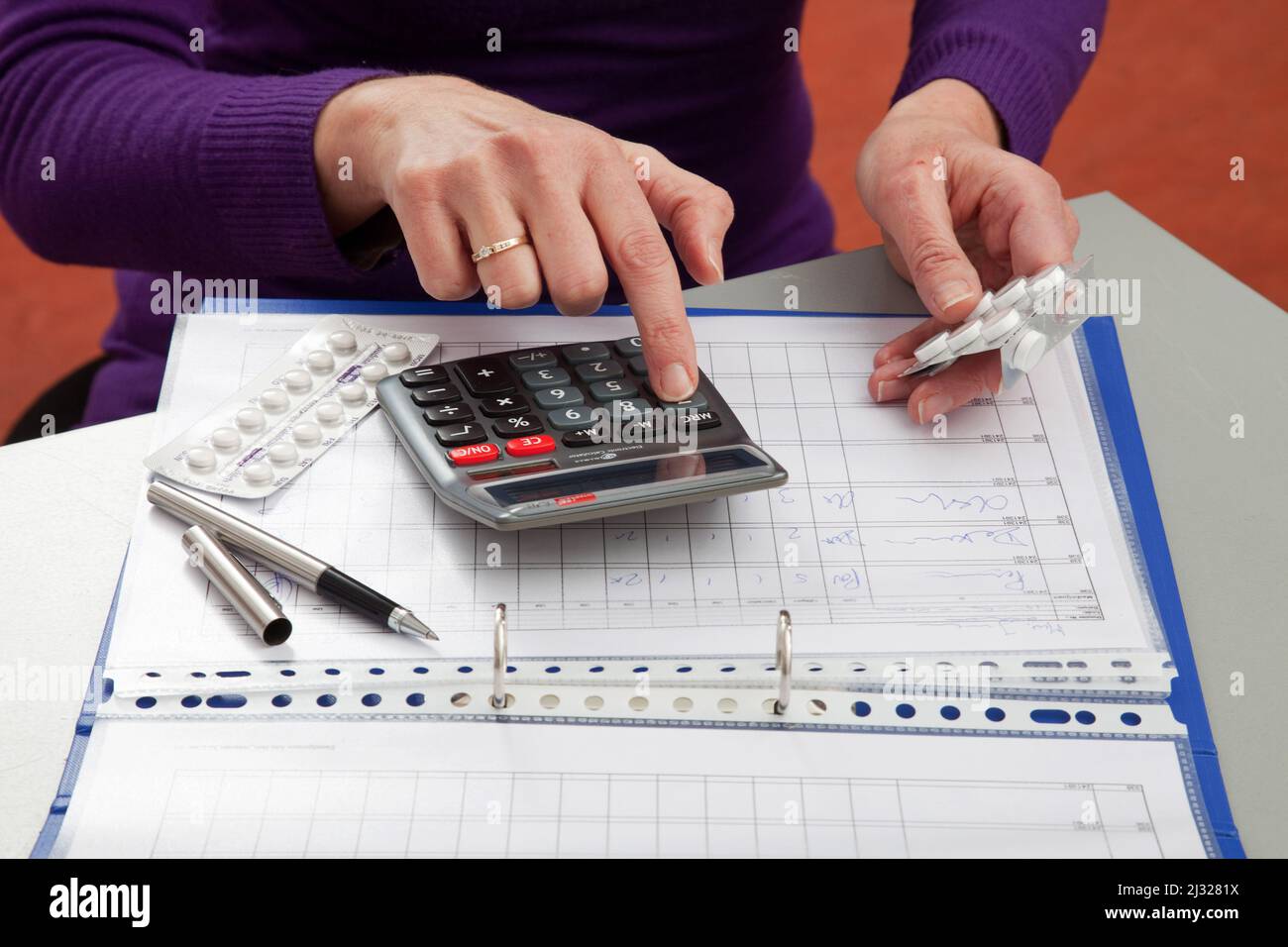 A healthcare provider is checking the medical record of a patient to see how much of a medicine she has to give. Therefor she needs to calculate the n Stock Photo