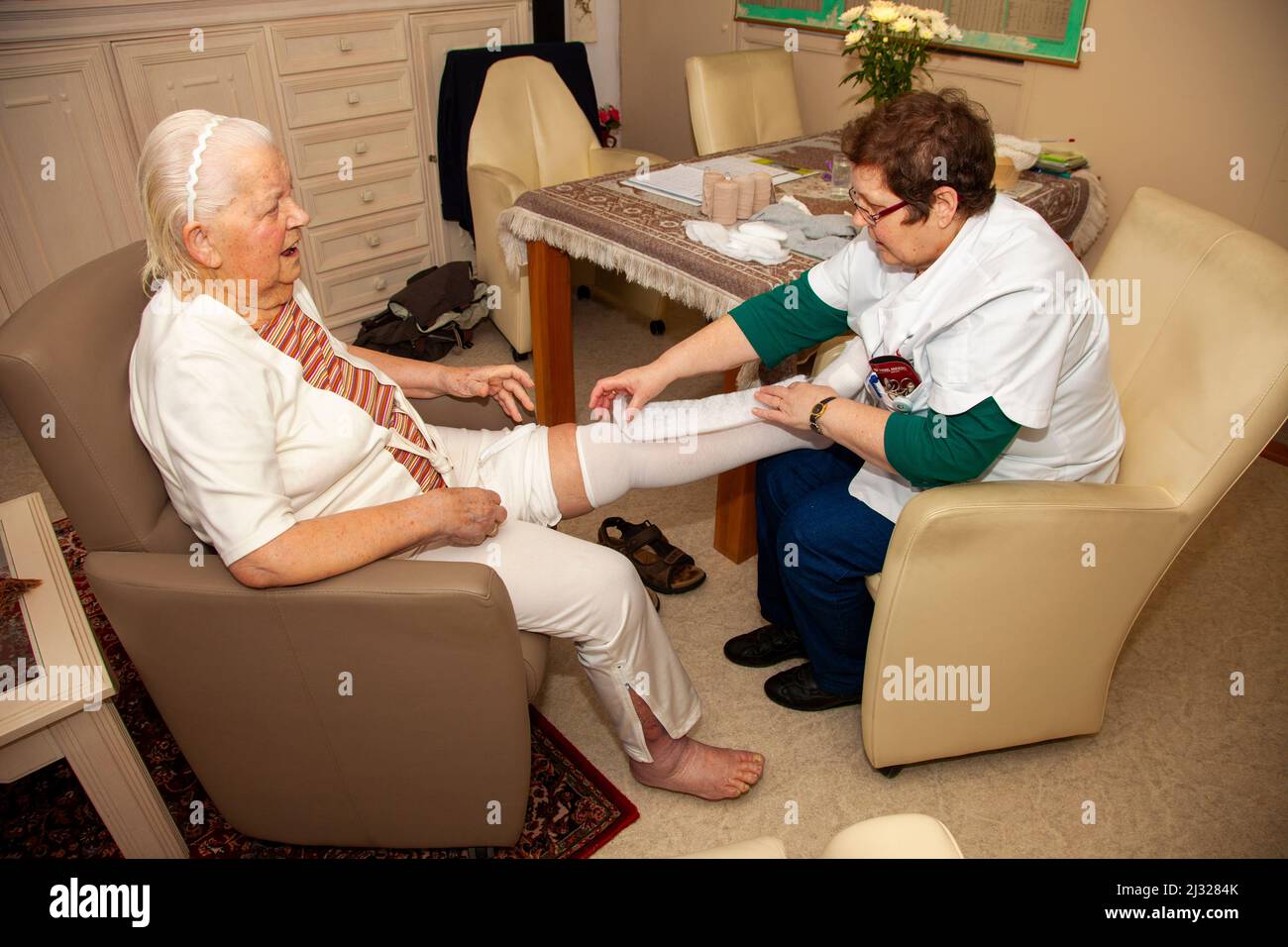Netherlands, nurse of an home care organisation applies compression