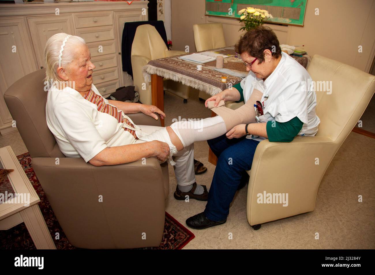 Netherlands, nurse of an home care organisation applies compression