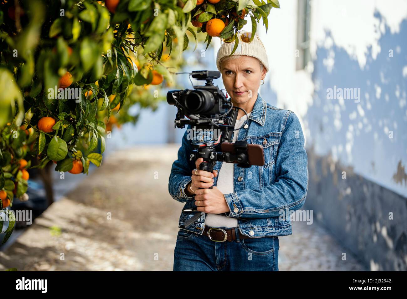 Camera operator with movie setup including a gimbal, video transmitter and wireless microphone Stock Photo