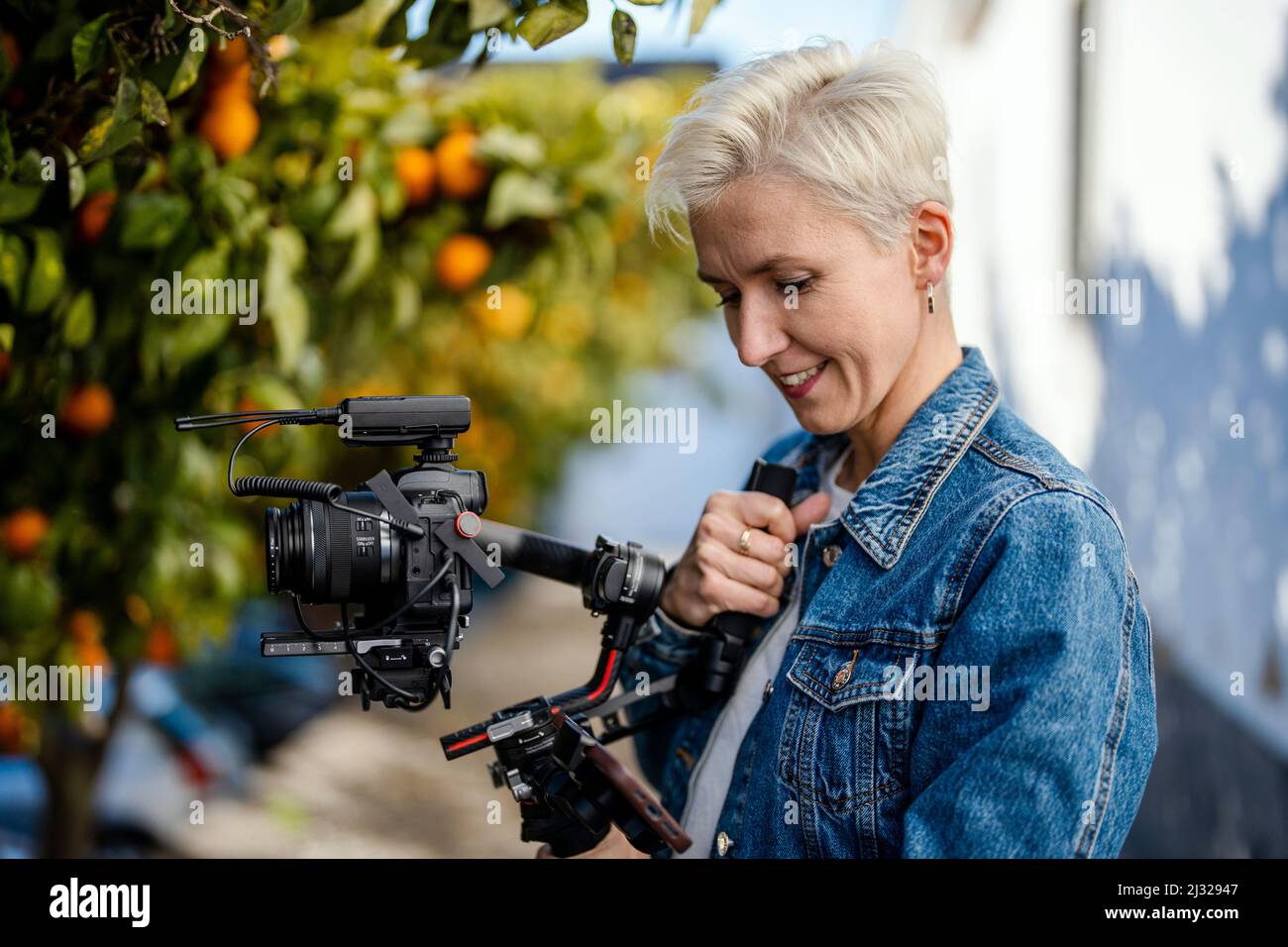Camera operator with movie setup including a gimbal, video transmitter and wireless microphone Stock Photo