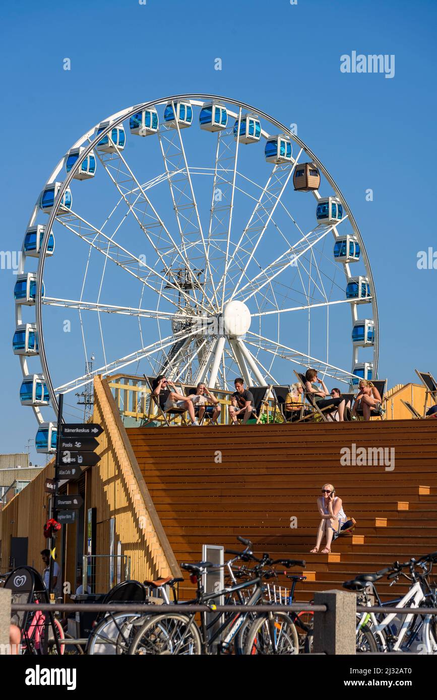 Roof terrace of Allas Sea Pool and ferris wheel with sauna gondola at