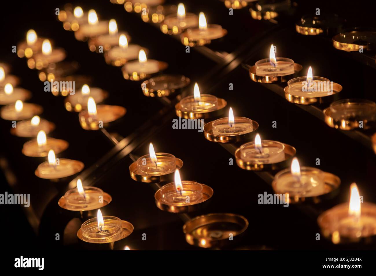Prayer candles lit with flames Stock Photo Alamy
