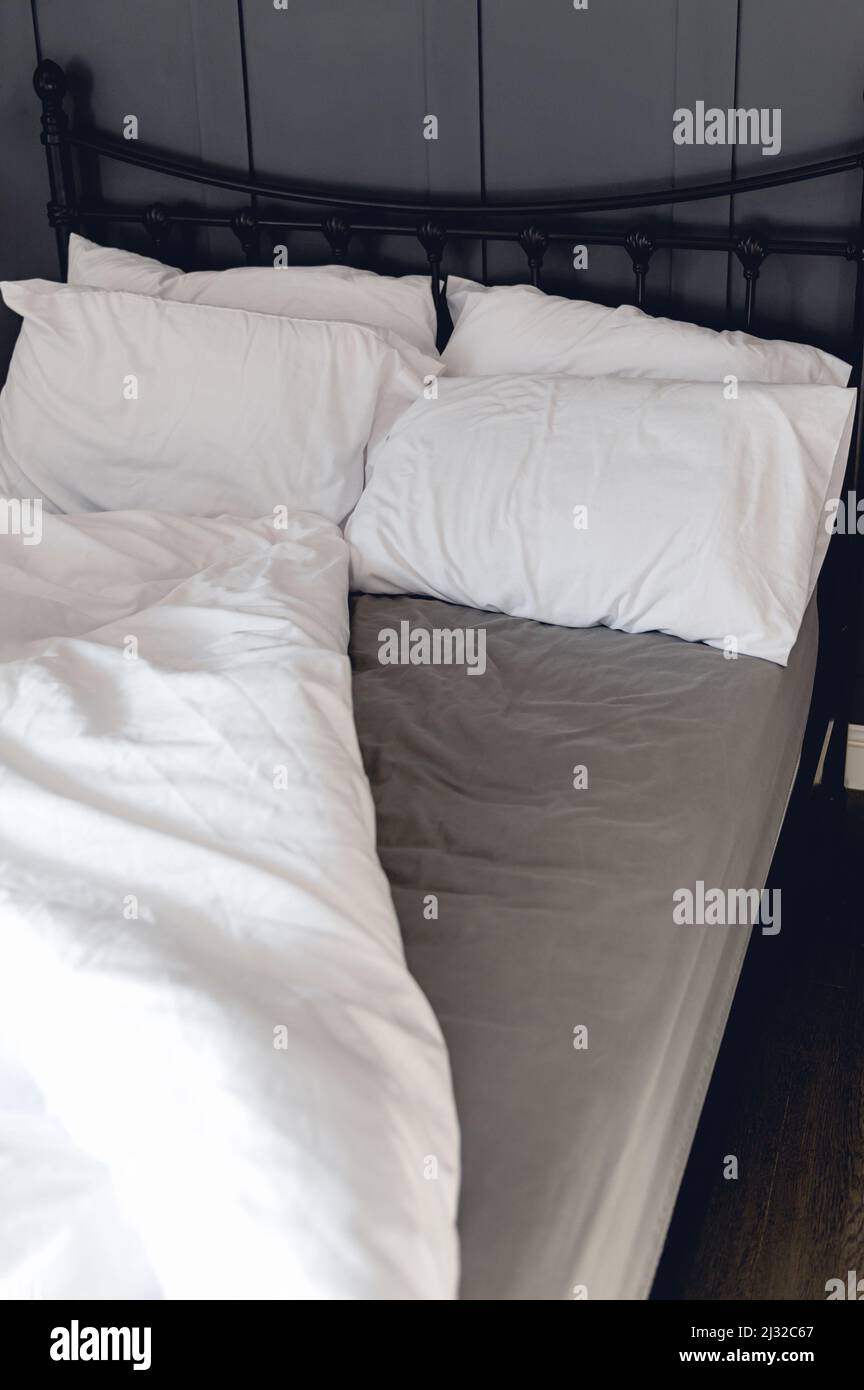 Soft pillows and duvet on comfortable bed Stock Photo