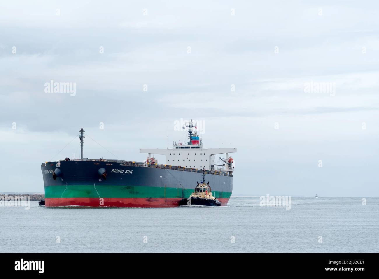 28th February 2022: The bulk ore carrier ship Rising Sun, registered in Japan, enters Newcastle Harbour in Australia Stock Photo