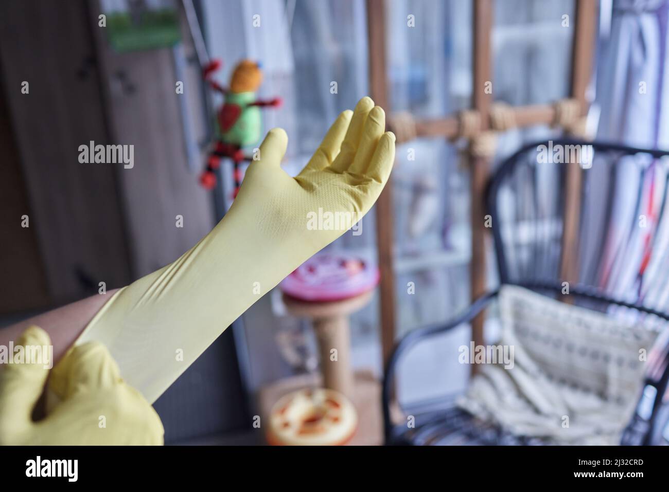 Young man wearing yellow rubber gloves. Ready to cleaning Stock Photo