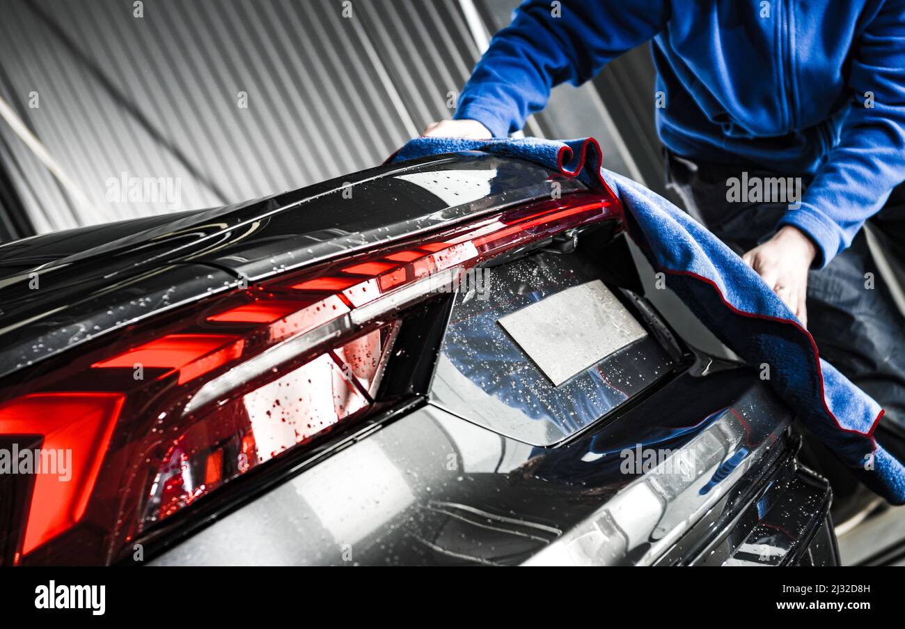 Professional Car Detailing Worker Cleaning Modern Vehicle Body with Soft Cloth. Automotive
