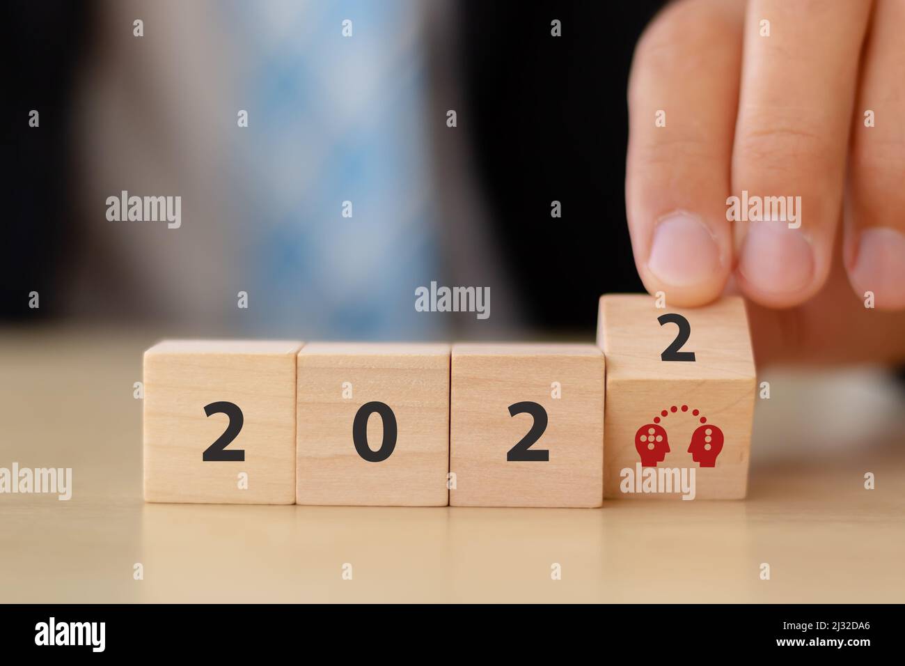Skill and knowledge transfer concept in 2022. Skill exchange and  management for digital transformation. Hand flips wood cubes with re-skill icon in 2 Stock Photo