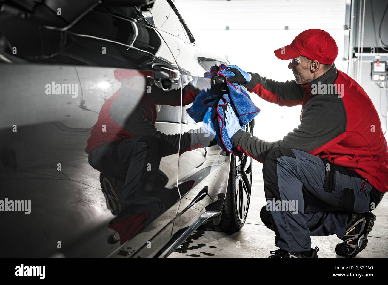 Professional Automotive Worker Cleaning Car Body Using Soft Cloth Right