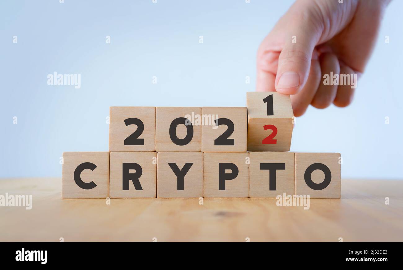 Cryptocurrency stock market concept. Trading on digital exchange in 2022.  Virtual money concept. Mining or blockchain technology. Hand flips wood  cube Stock Photo - Alamy