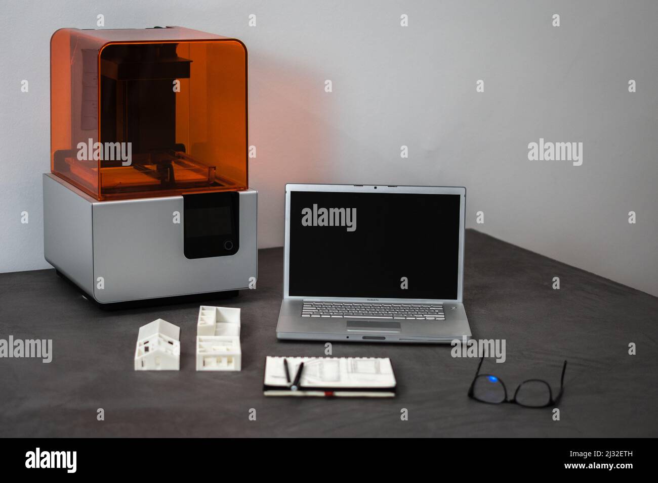 A 3D printer laptop mass model on an office table Stock Photo