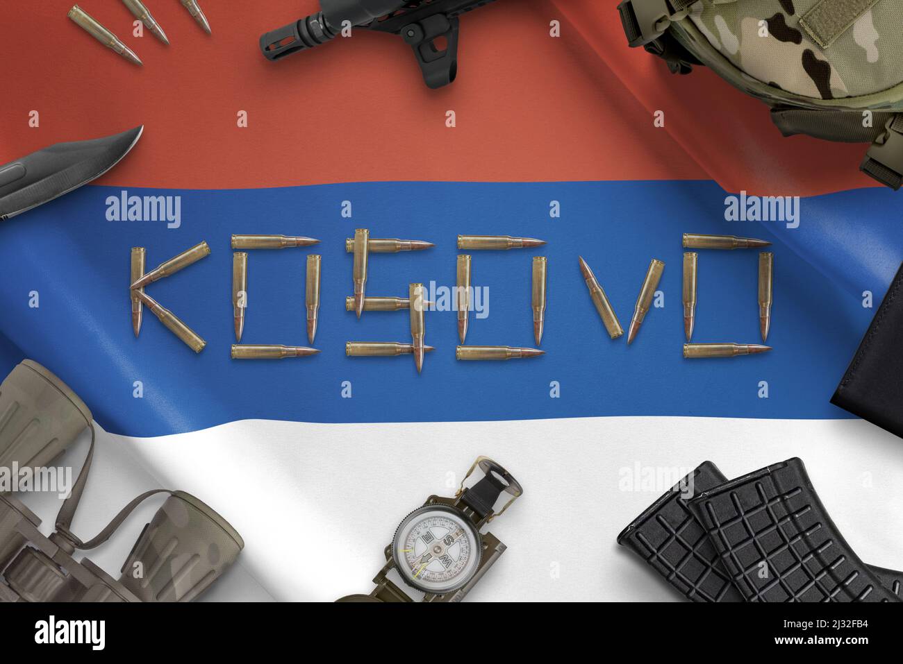 Kosovo with bullets writen on Serbia flag surrounded by military equipment. Independence conflict concept Stock Photo