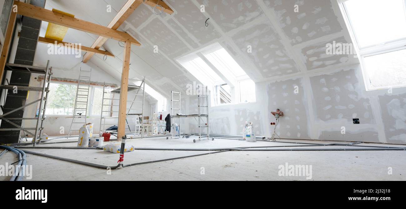 Attic finishing construction site in the phase drywall spackling and plastering before screeding