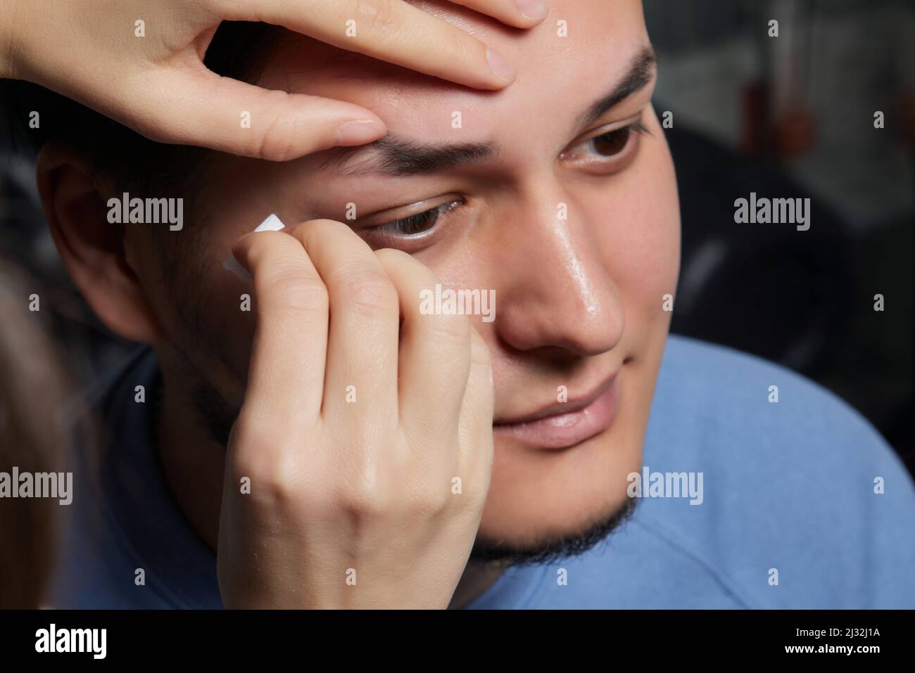 Professional barber doing threading procedure and correcting shape of