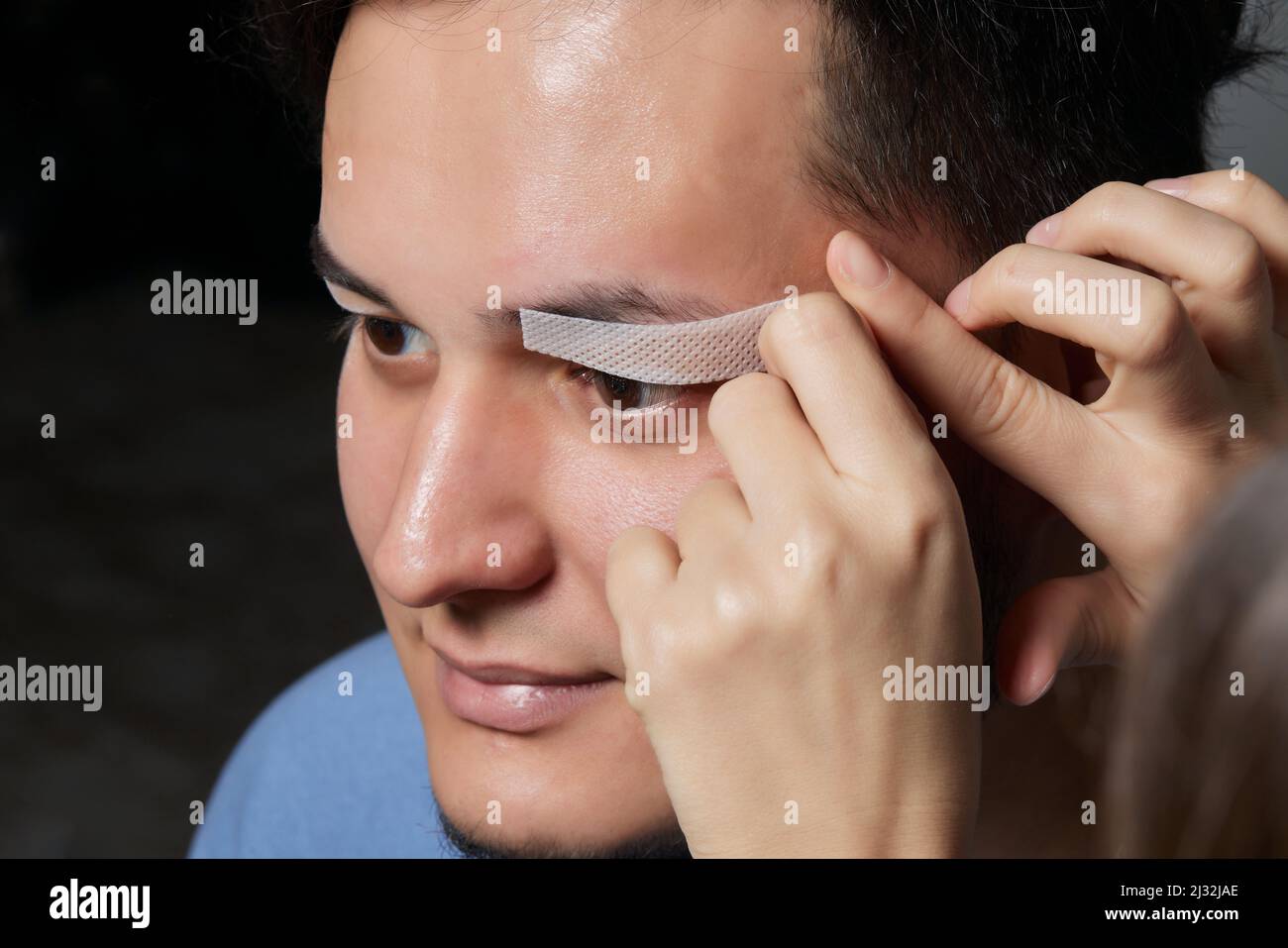 Professional barber doing threading procedure and correcting shape of