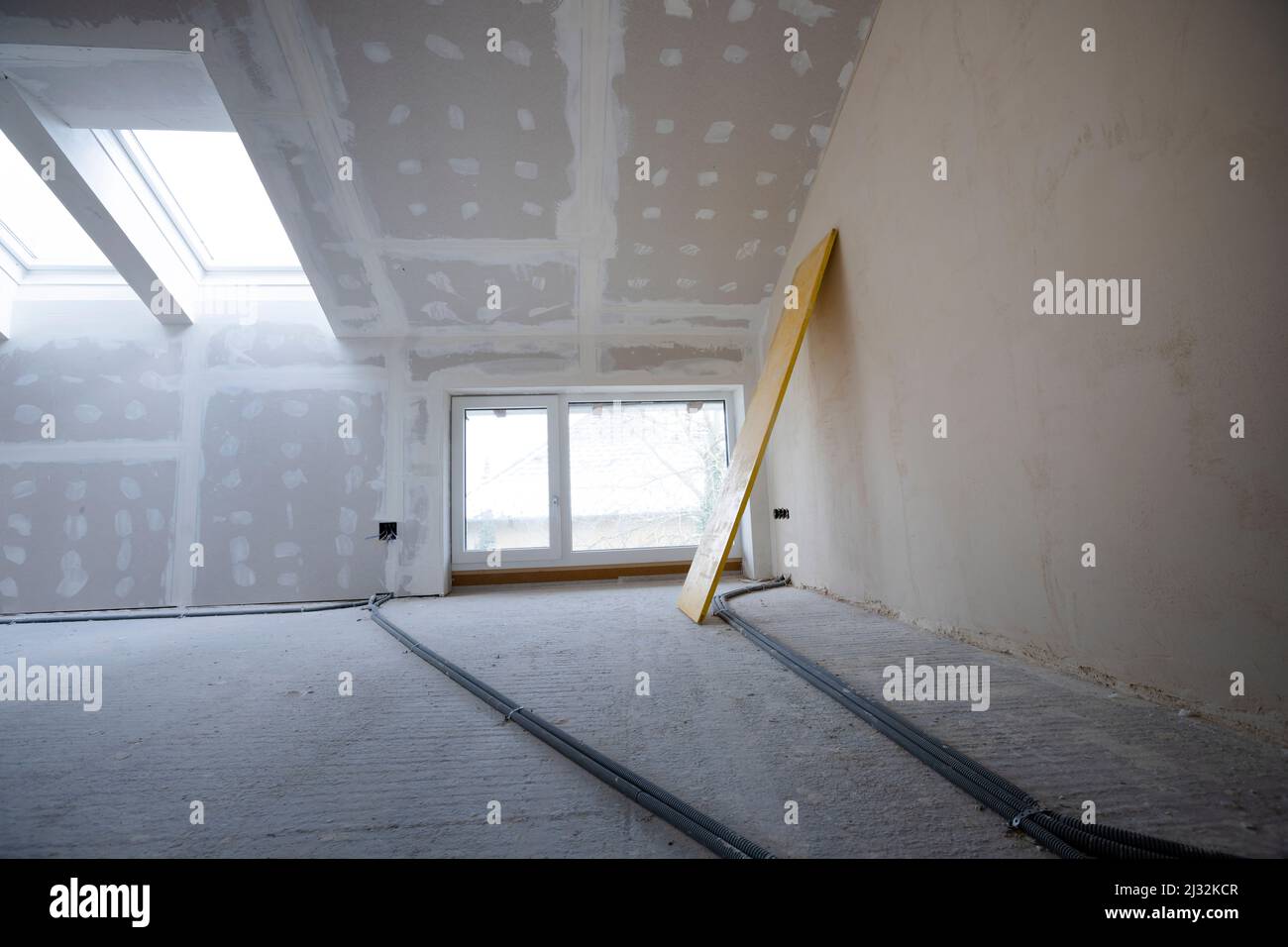 Attic finishing construction site in the phase drywall spackling and plastering before screeding