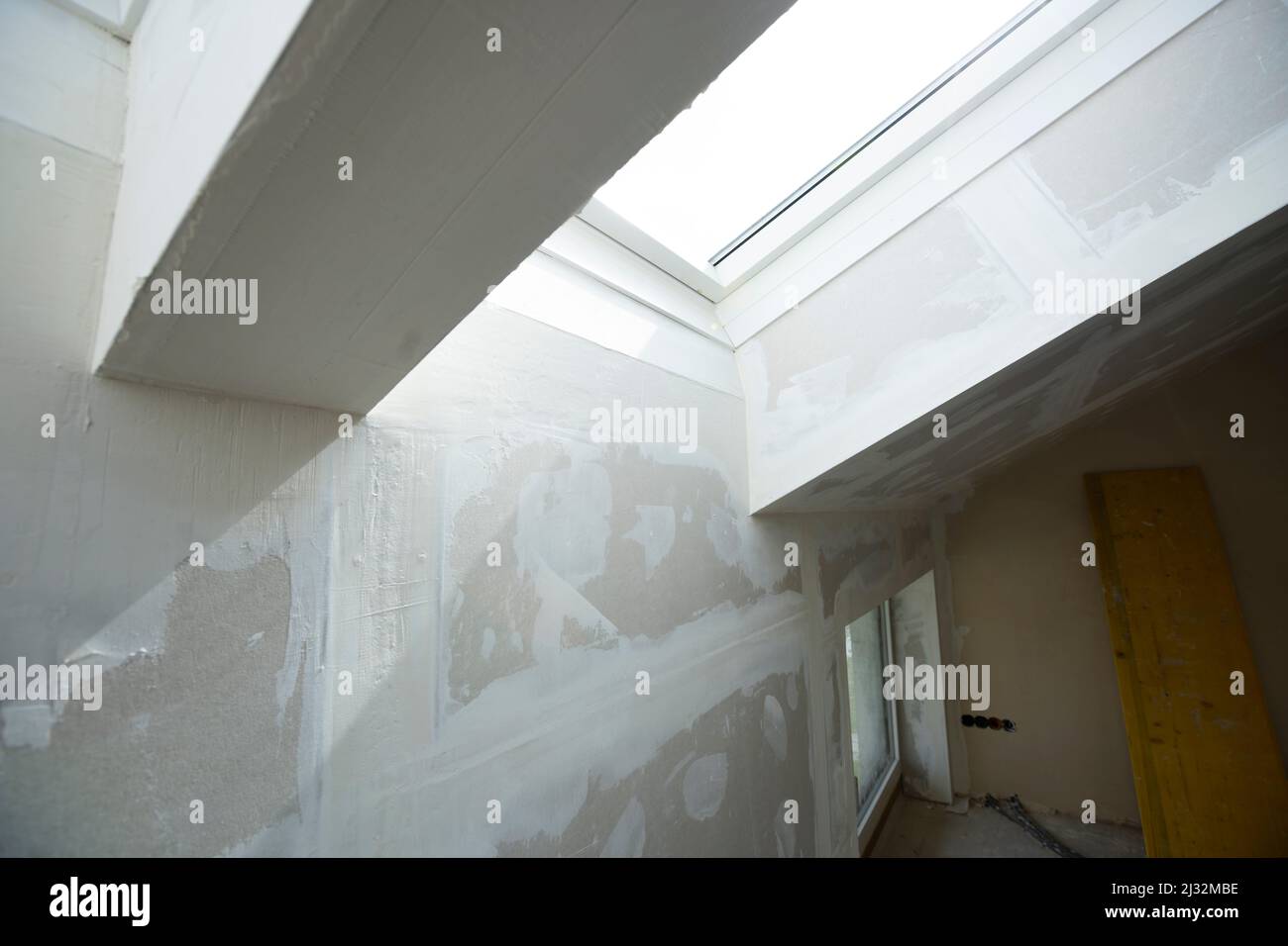 Attic finishing construction site in the phase drywall spackling and plastering before screeding