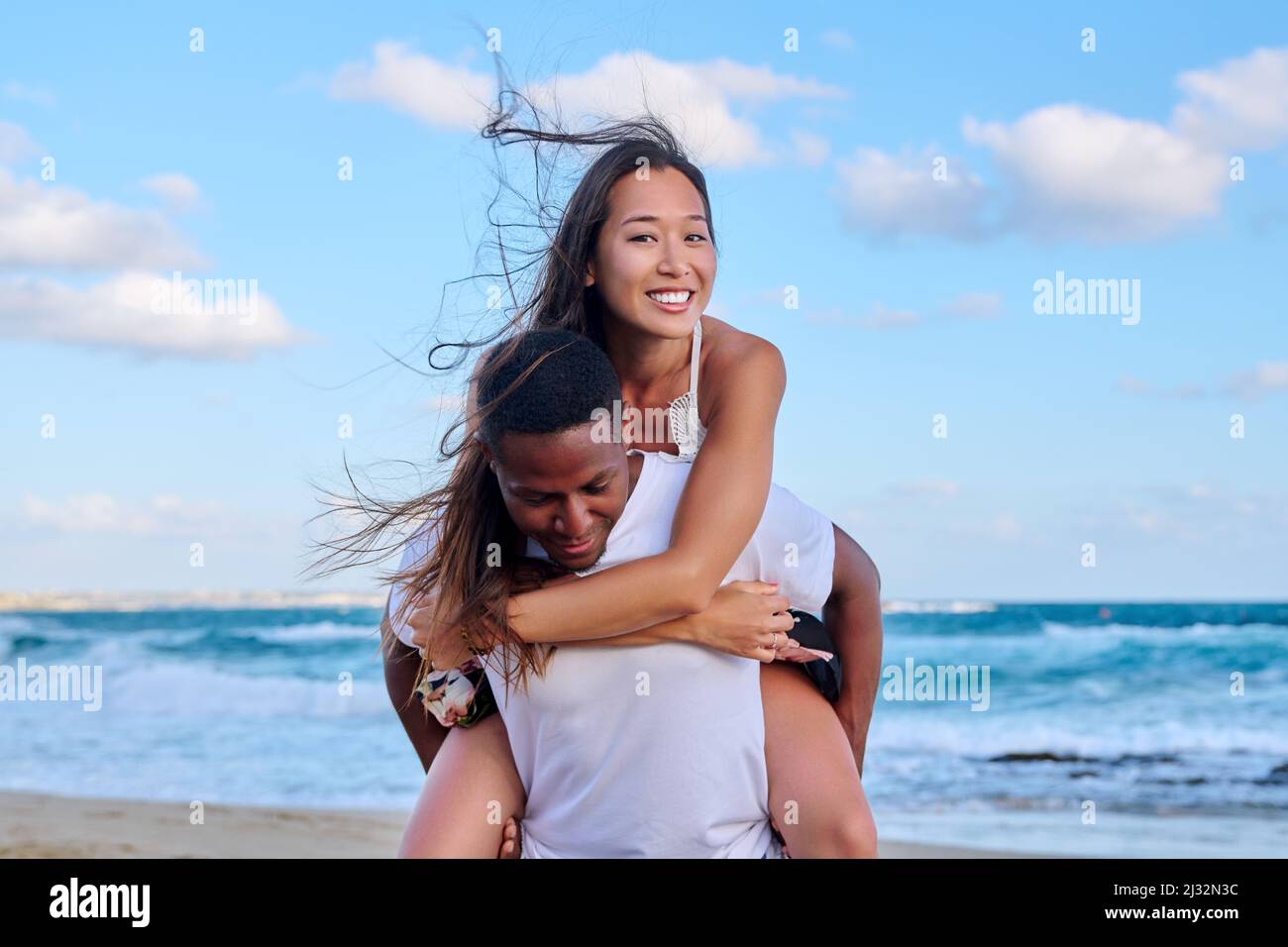 Happy young beautiful couple having fun on the beach. Stock Photo