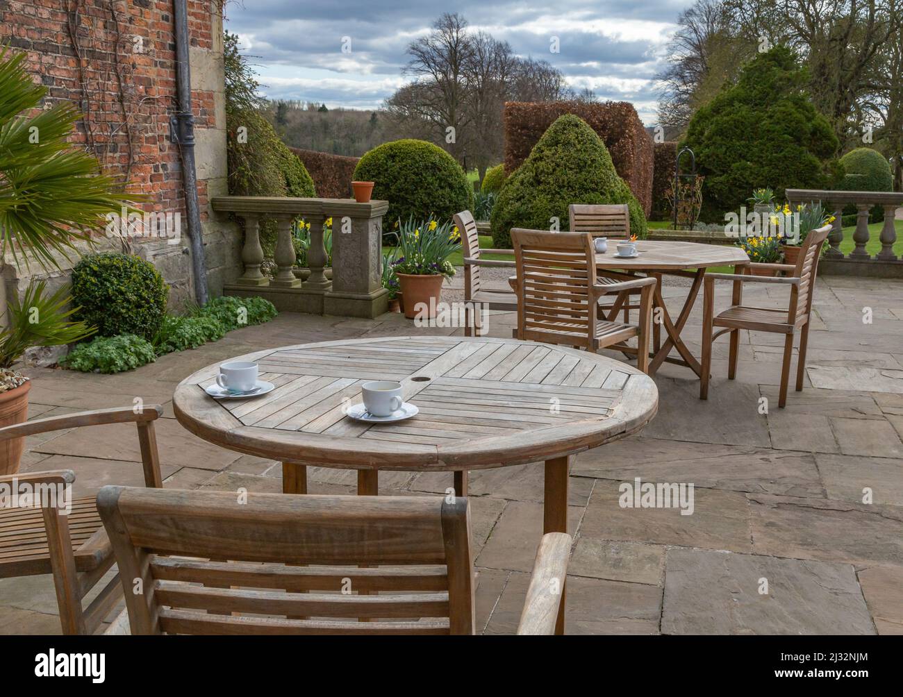 Wooden garden tables and chairs on the patio of Goldsborough Hall