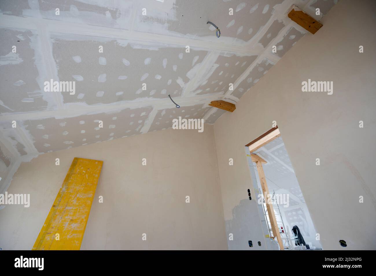 Attic finishing construction site in the phase drywall spackling and plastering before screeding