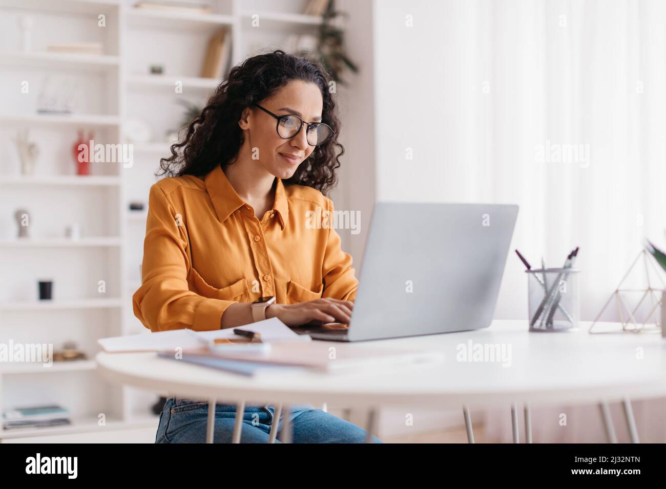 Middle Eastern Lady Using Laptop Working Online Sitting In Office Stock Photo