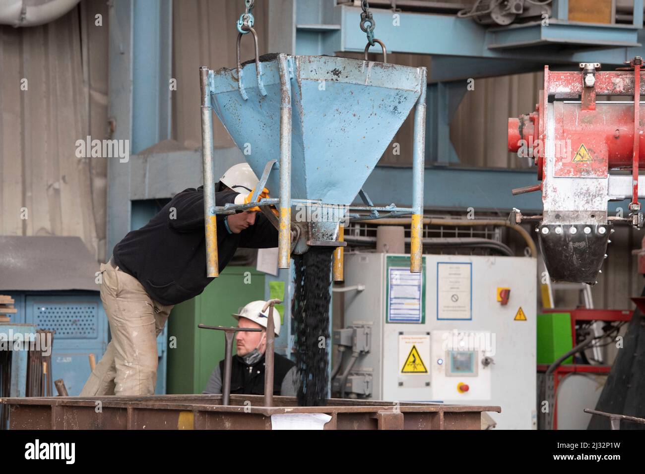 Workers prepare a casting mold with molding sand, blast furnace, molten steel, visit of Federal Workers prepare a casting mold with molding sand, blast furnace, molten steel, visit of Federal