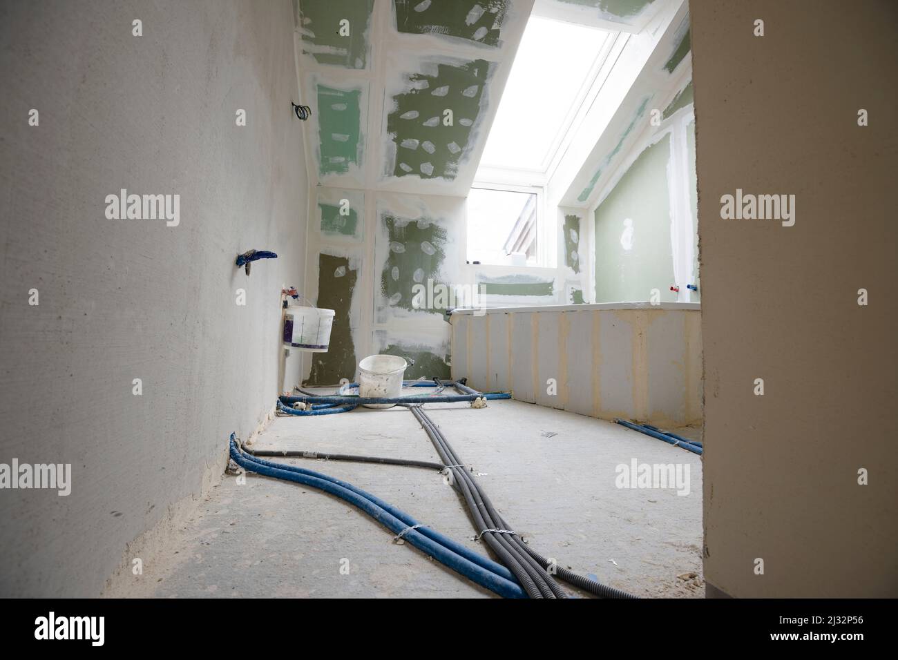 Attic finishing construction site in the phase drywall spackling and plastering before screeding