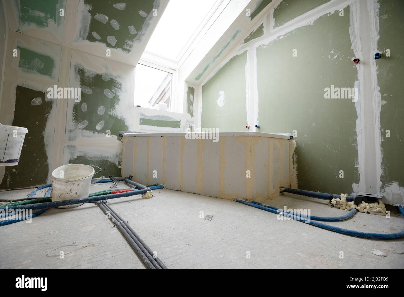 Attic finishing construction site in the phase drywall spackling and plastering before screeding
