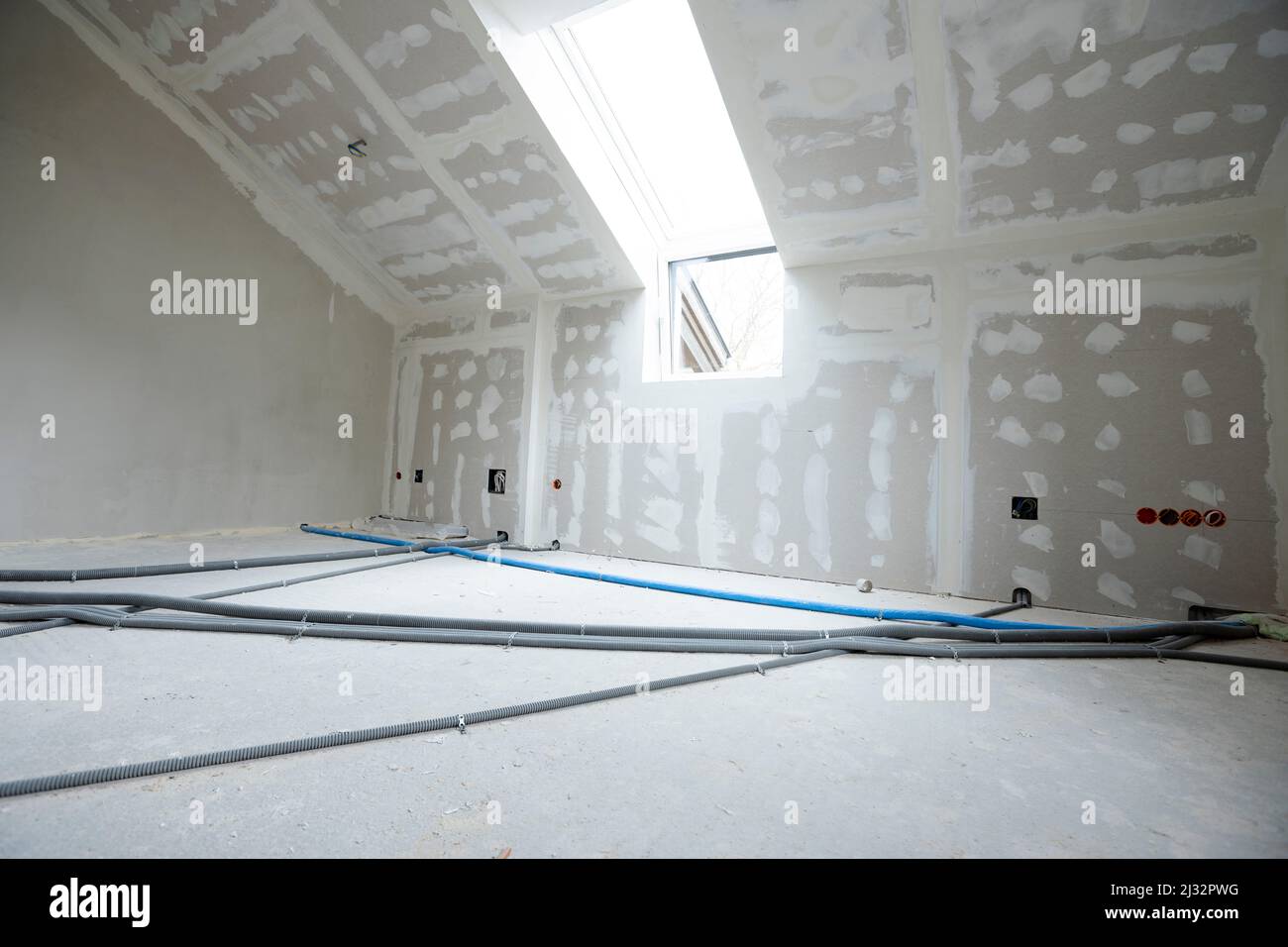 Attic finishing construction site in the phase drywall spackling and plastering before screeding