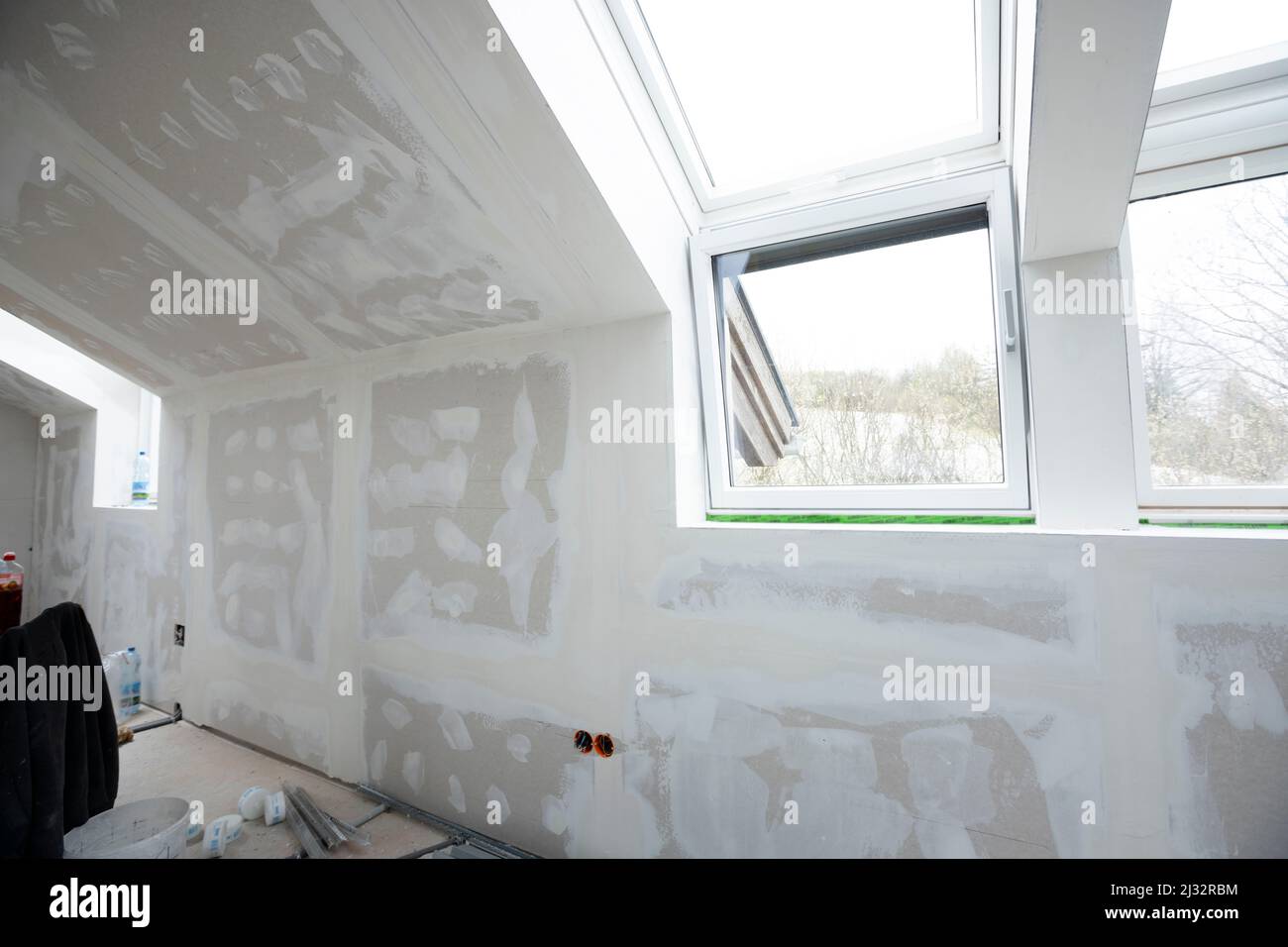 Attic finishing construction site in the phase drywall spackling and plastering before screeding