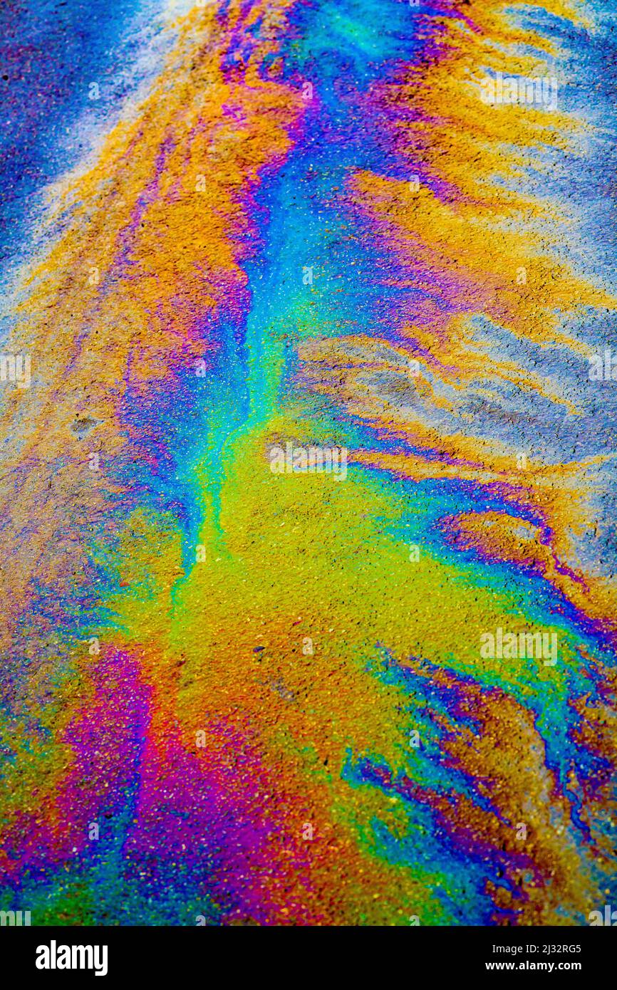 Many Colours produced by an oil leak on a wet road. Stock Photo