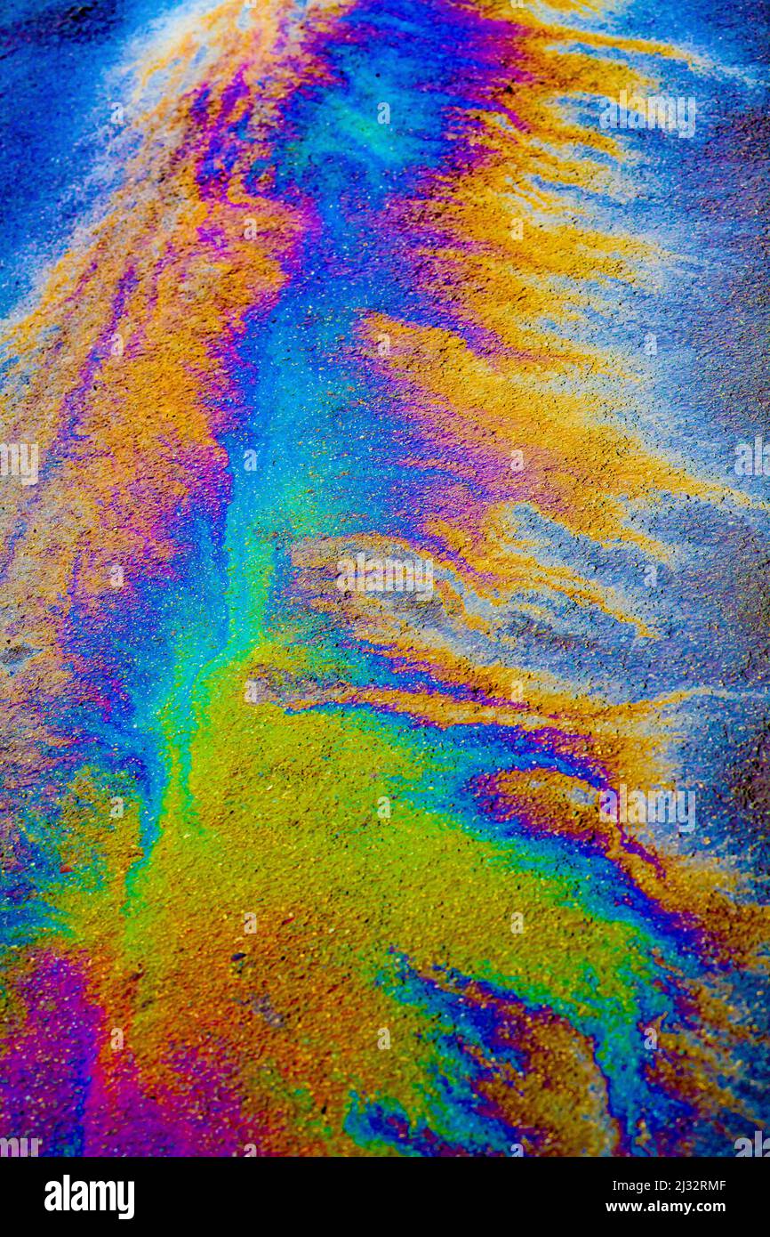 Many Colours produced by an oil leak on a wet road. Stock Photo