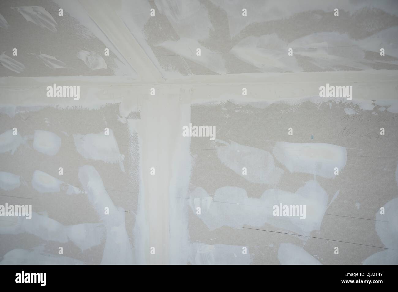 Attic finishing construction site in the phase drywall spackling and plastering before screeding