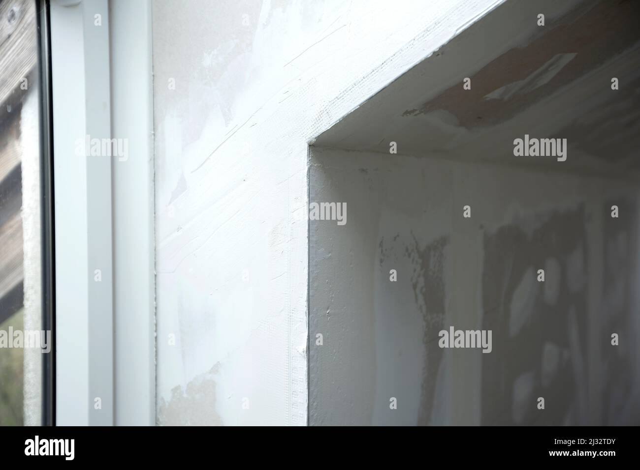 Attic finishing construction site in the phase drywall spackling and plastering before screeding