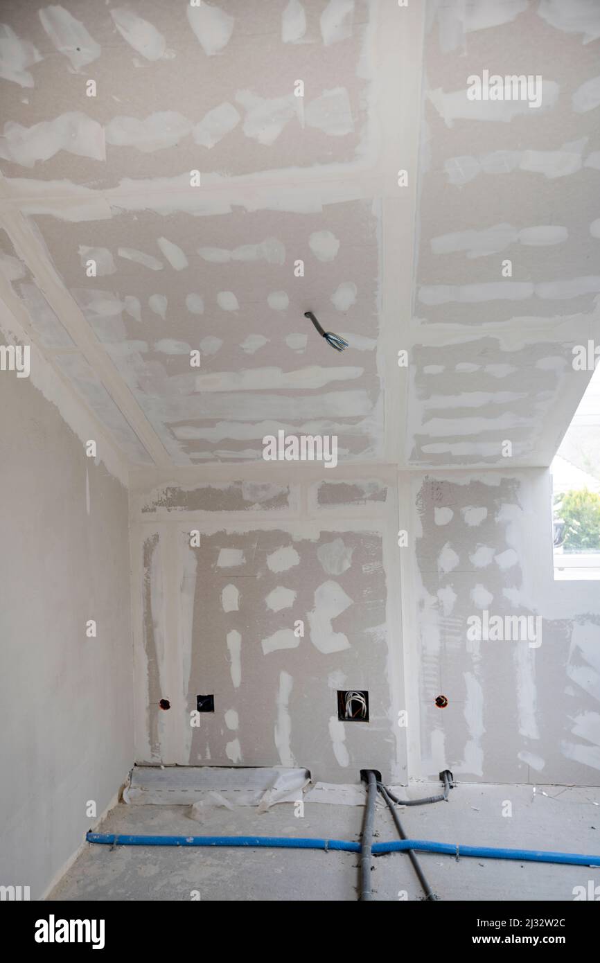 Attic finishing construction site in the phase drywall spackling and plastering before screeding