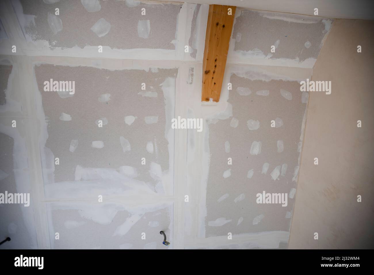 Attic finishing construction site in the phase drywall spackling and plastering before screeding