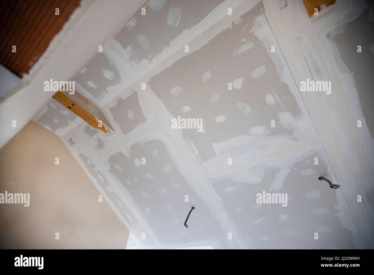 Attic finishing construction site in the phase drywall spackling and plastering before screeding