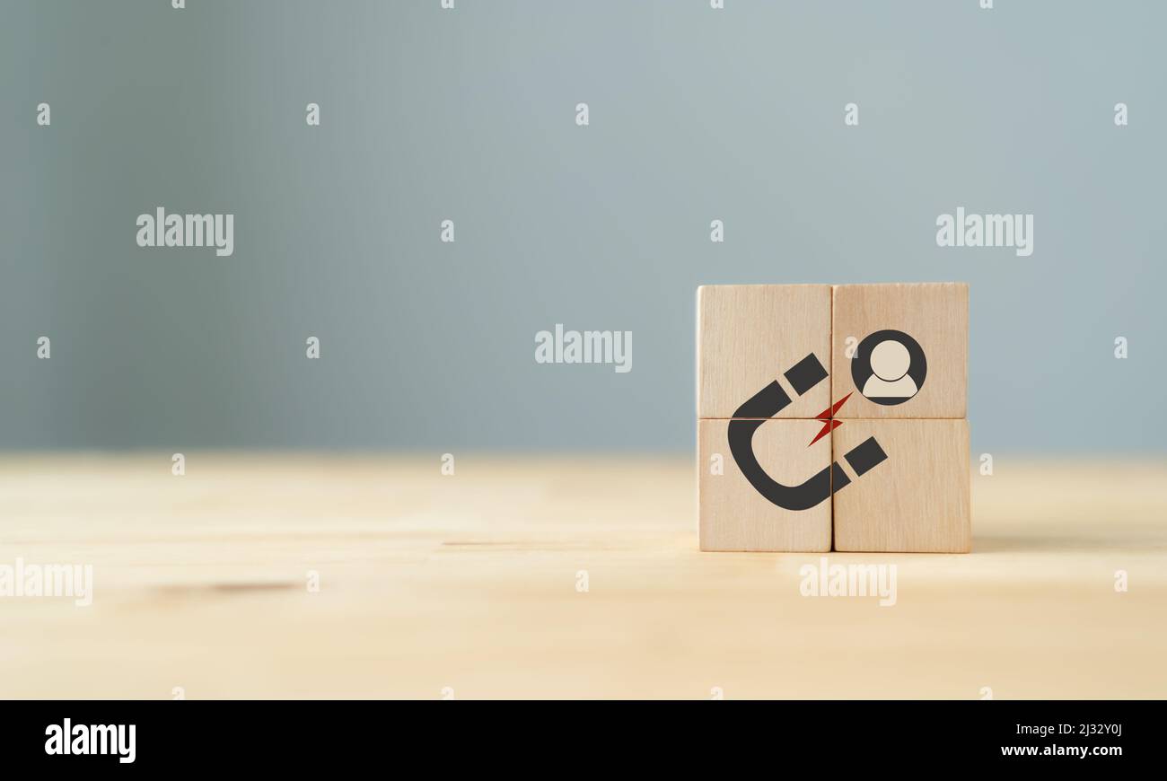 Lead generation, customer retention concept. Inbound marketing strategy. The wooden cubes with magnet attracts customer icons on beautiful grey backgr Stock Photo