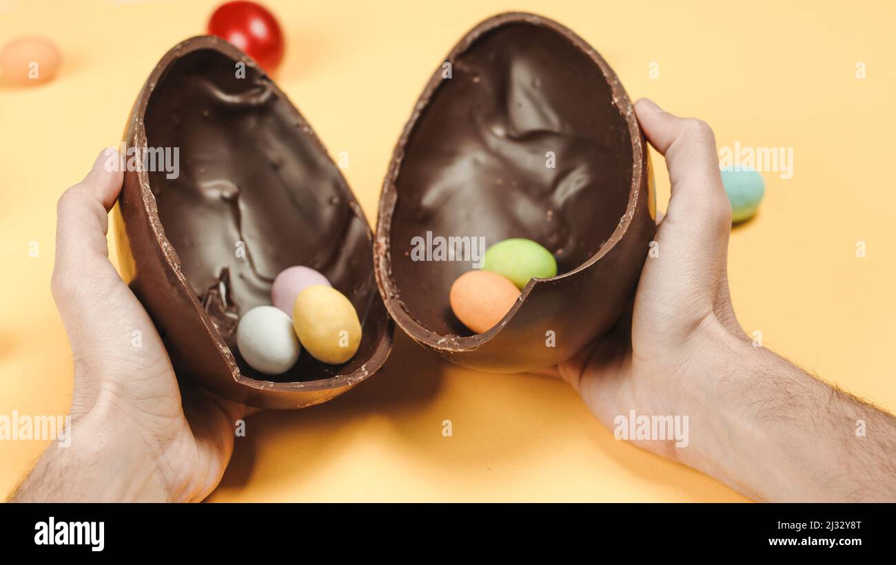 Chocolate easter egg with the top broken off Stock Photo - Alamy