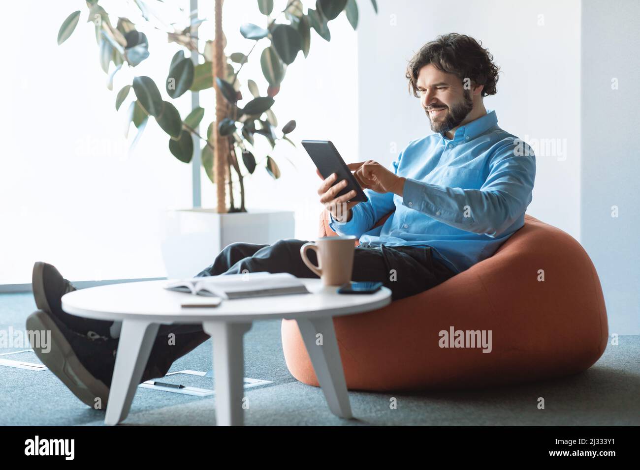 Portrait of smiling man using digital tablet at office Stock Photo